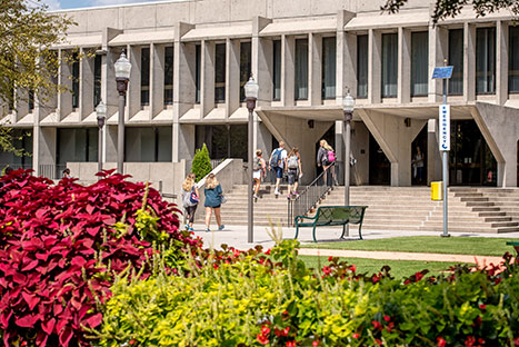 Students walking up the stairs to a building. Links to Beneficiary Designations